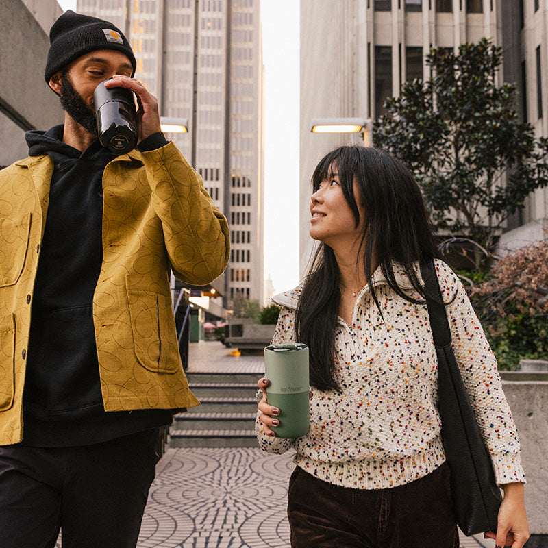16oz-rise-tumbler-o7 16oz_rise_tumbler_black_iceberg_couple_drink_city_street_square.jpg
