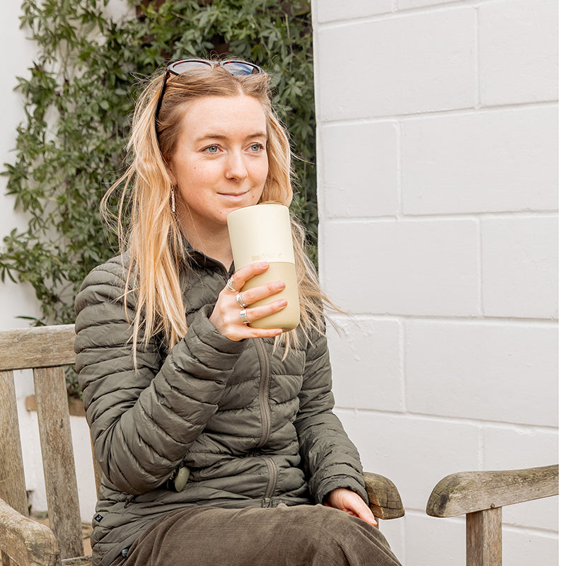 16oz-rise-tumbler-o7 16oz_rise_tumbler_wax_yellow_woman_seat_outside_square.jpg