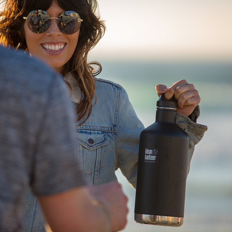 64oz-classic-with-loop-cap-a3 64oz_insulated_classic_black_beach_girl_hand_square.jpg